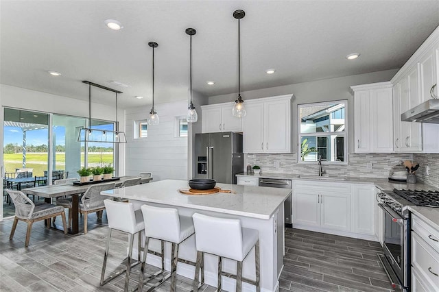 kitchen featuring white cabinets, appliances with stainless steel finishes, and a kitchen island