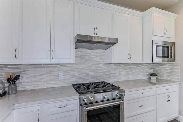 kitchen with exhaust hood, decorative backsplash, stainless steel appliances, and white cabinetry