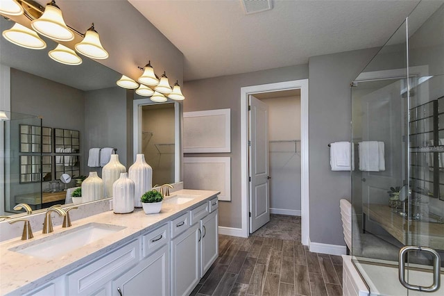 bathroom with walk in shower and vanity