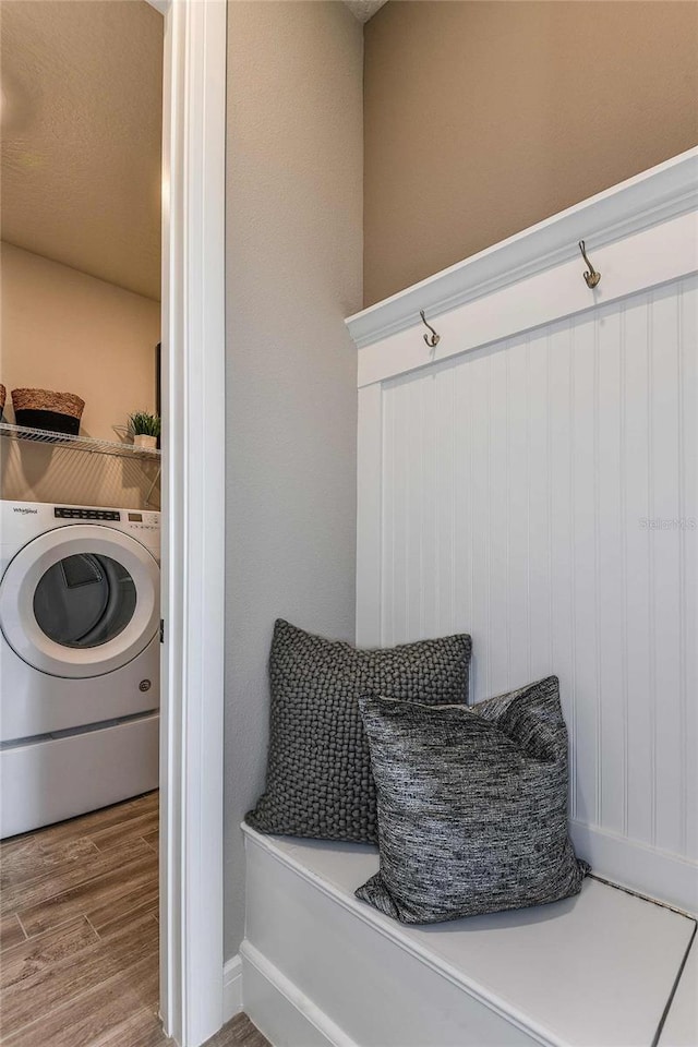 mudroom with hardwood / wood-style floors and washer / clothes dryer