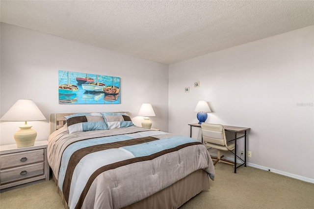 bedroom with light carpet and a textured ceiling