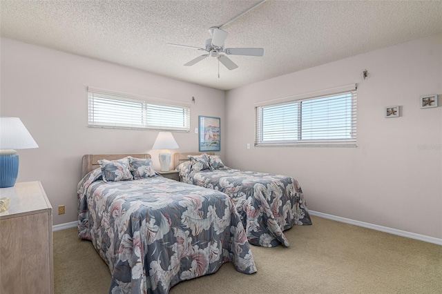 carpeted bedroom with a textured ceiling and ceiling fan