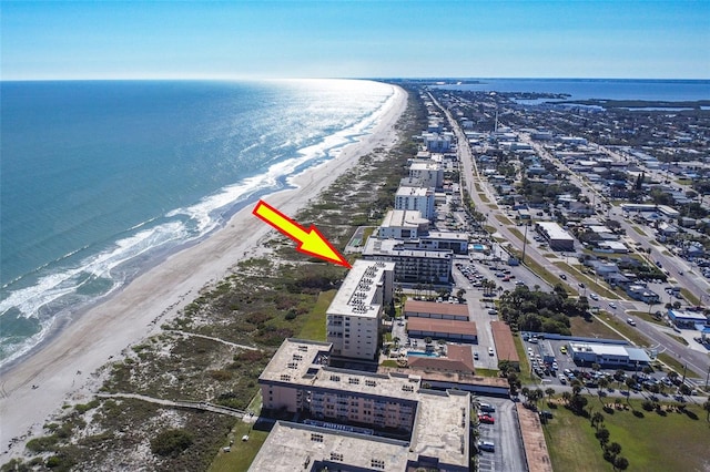 aerial view with a water view and a beach view