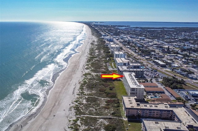 birds eye view of property with a water view and a view of the beach