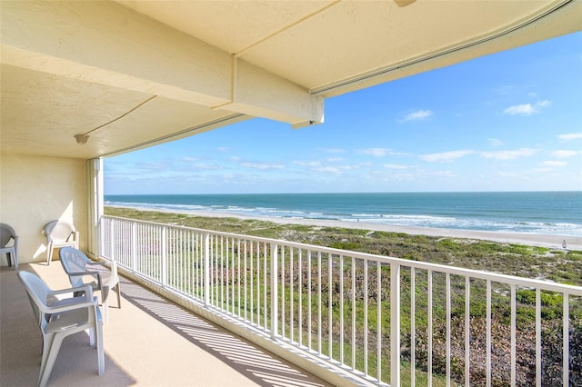 balcony with a water view and a beach view