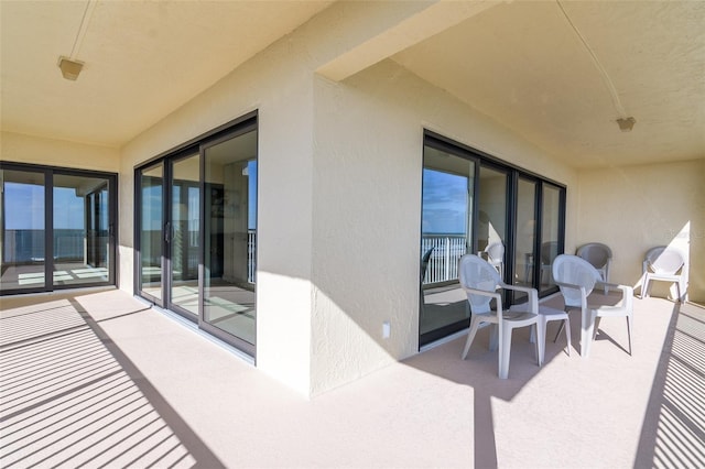 view of patio featuring a balcony