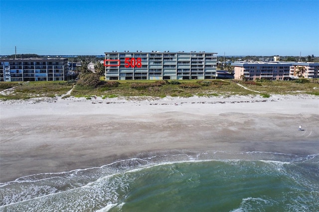 birds eye view of property with a beach view and a water view