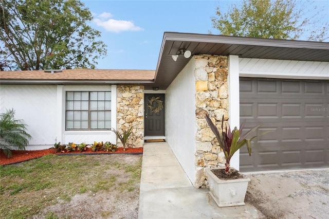 view of exterior entry with a garage