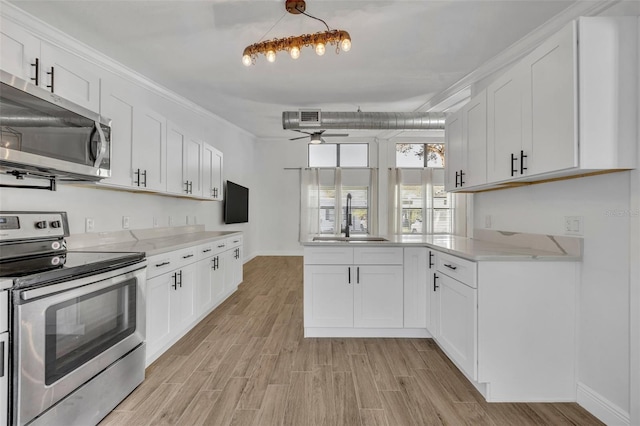 kitchen with ceiling fan, sink, white cabinetry, and stainless steel appliances