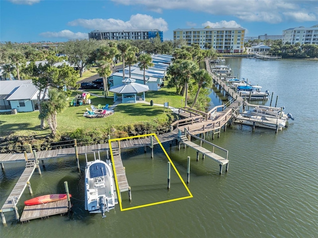 dock area with a water view and a lawn