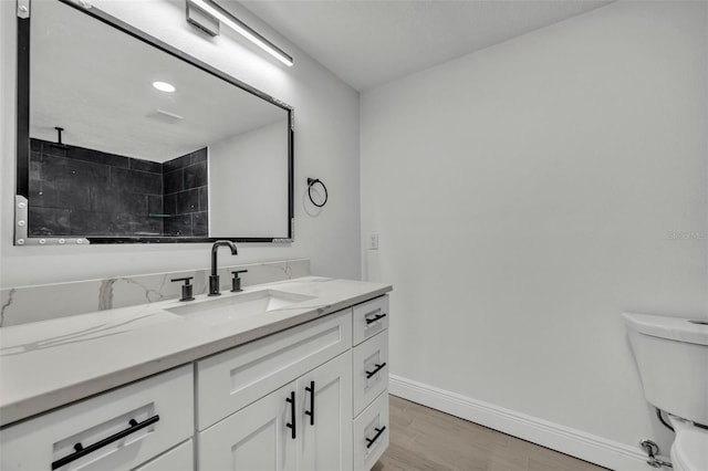 bathroom with toilet and vanity