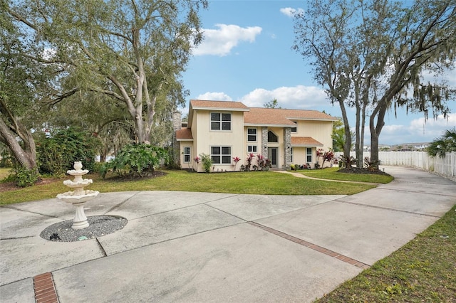 mediterranean / spanish house featuring a front yard