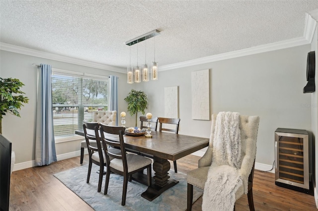 dining space featuring wine cooler, a wealth of natural light, and ornamental molding