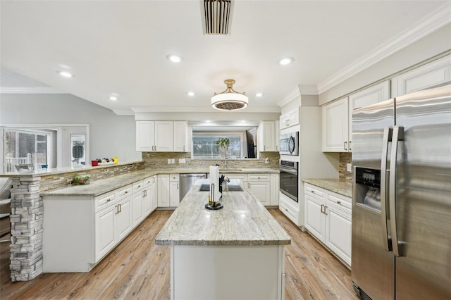 kitchen with appliances with stainless steel finishes, white cabinetry, backsplash, kitchen peninsula, and light stone counters