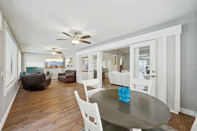 dining room with ceiling fan, french doors, and hardwood / wood-style flooring