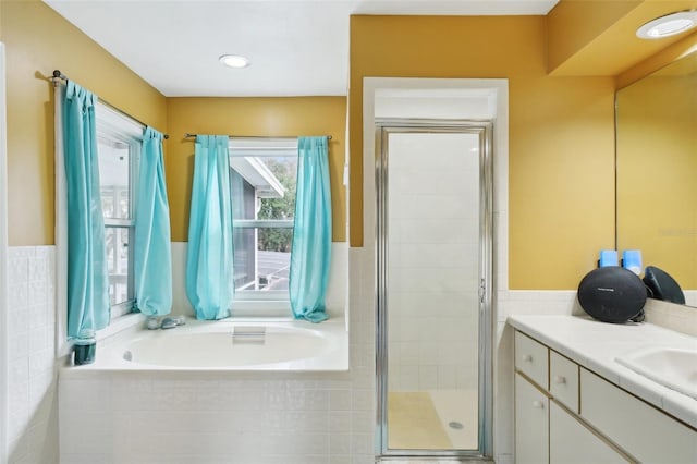 bathroom featuring separate shower and tub and vanity