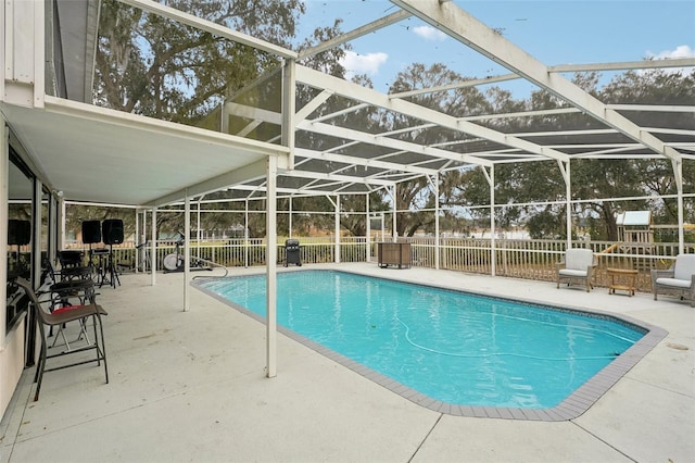 view of pool with a lanai and a patio