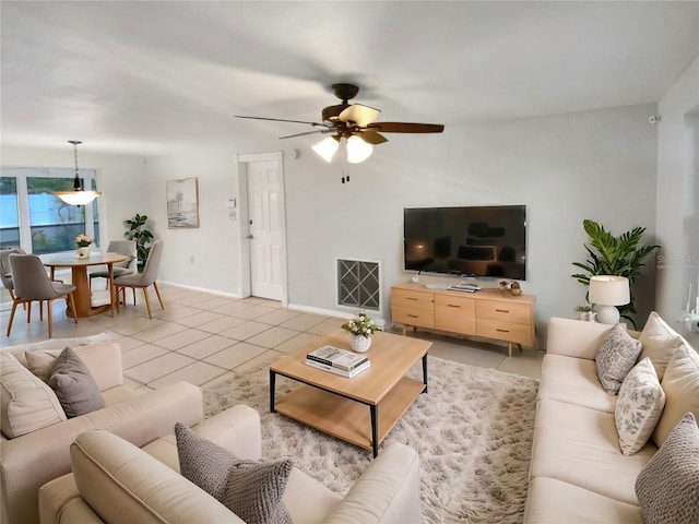 living room featuring ceiling fan and light tile patterned flooring