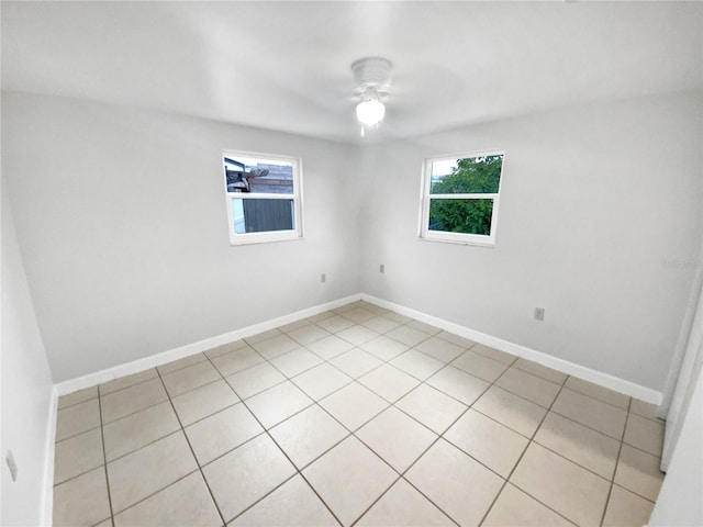 tiled empty room with ceiling fan