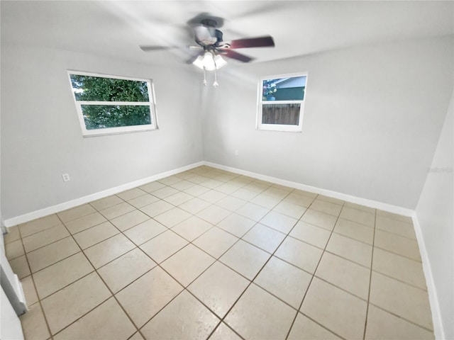 spare room featuring ceiling fan and light tile patterned floors