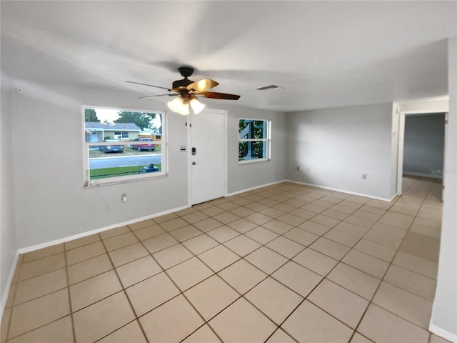 unfurnished room with ceiling fan and light tile patterned floors