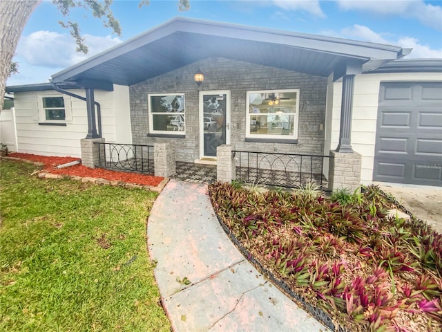 view of front of property with a garage and a front lawn