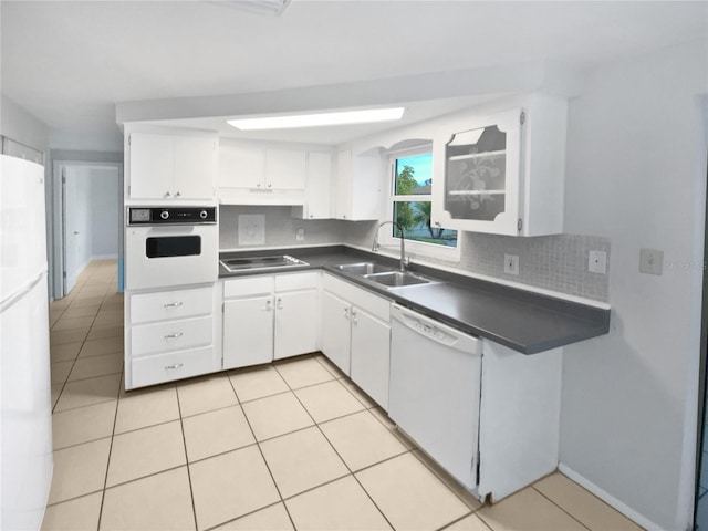 kitchen featuring light tile patterned floors, sink, white appliances, and white cabinets