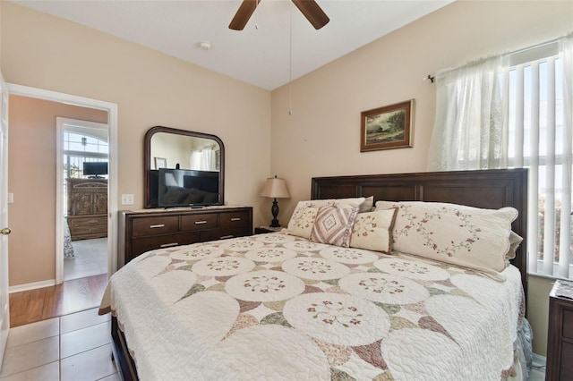 bedroom with light tile patterned flooring, ceiling fan, and vaulted ceiling