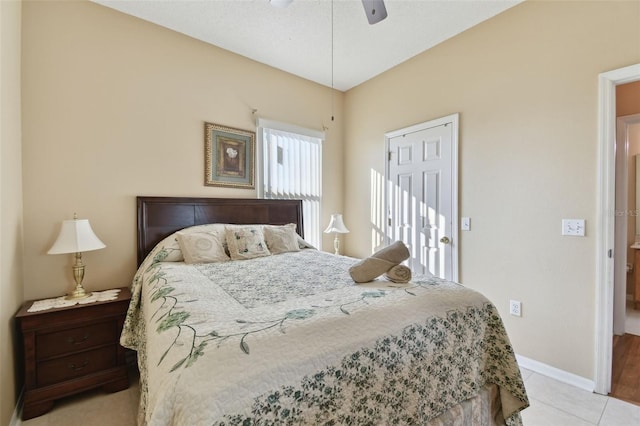 bedroom featuring light tile patterned floors, baseboards, and ceiling fan