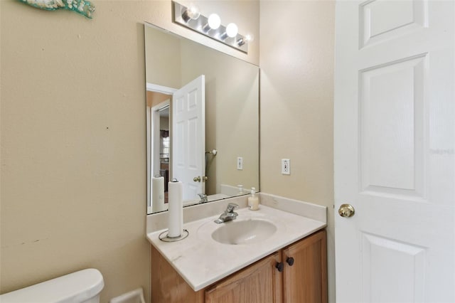 bathroom featuring toilet and vanity