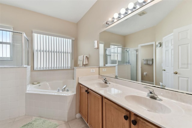 bathroom featuring plenty of natural light, a bath, and a sink