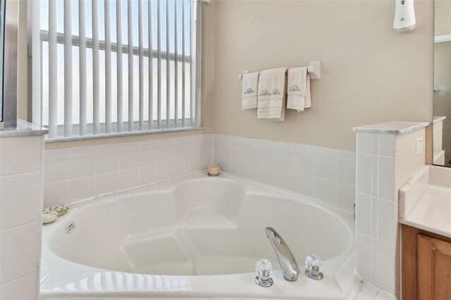 bathroom with vanity and a bath