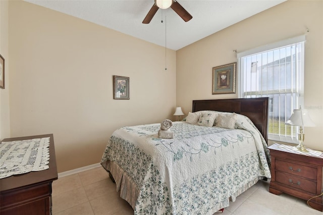 bedroom featuring light tile patterned floors, ceiling fan, and baseboards