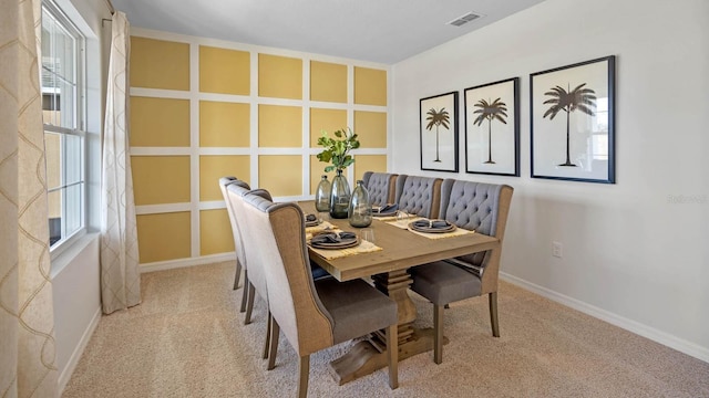 dining room featuring light colored carpet