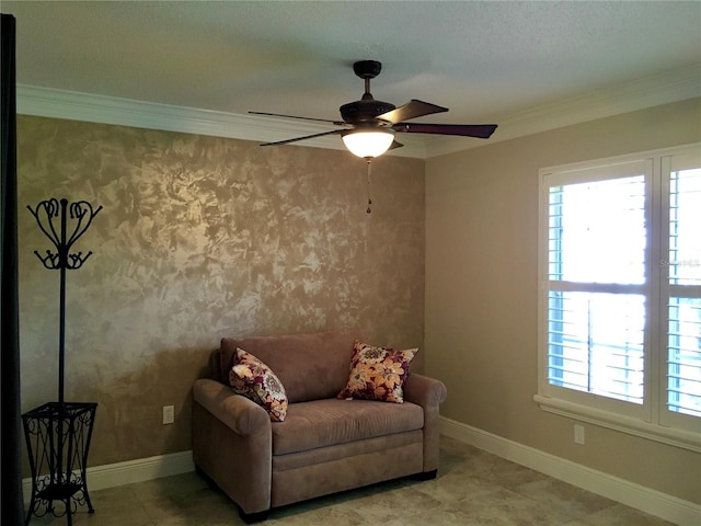 living area with ceiling fan and crown molding