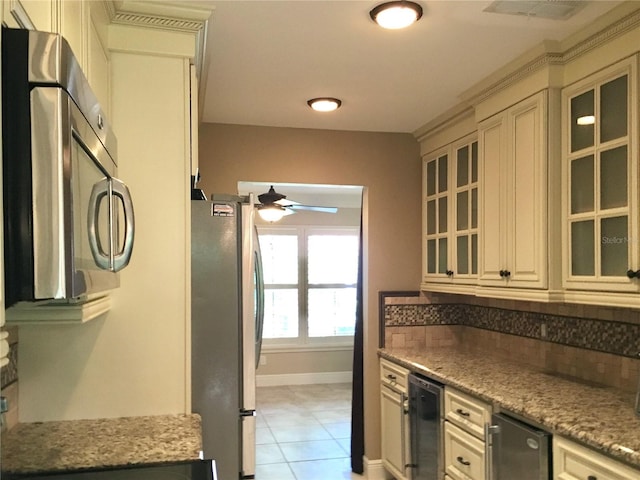 kitchen with cream cabinetry, wine cooler, and appliances with stainless steel finishes