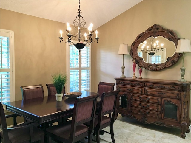 dining room with a wealth of natural light, an inviting chandelier, and lofted ceiling