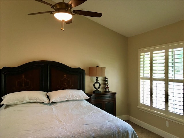 bedroom with ceiling fan, carpet flooring, and lofted ceiling