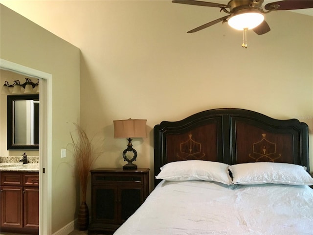 bedroom featuring sink, ceiling fan, and connected bathroom