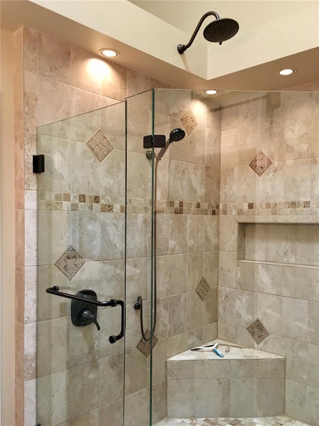 bathroom with a shower with door