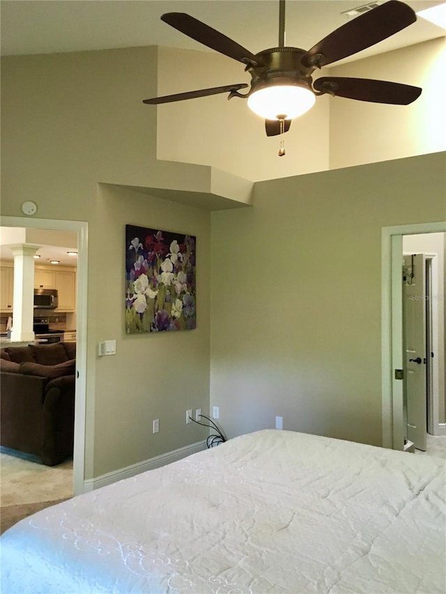 unfurnished bedroom featuring a towering ceiling and ceiling fan