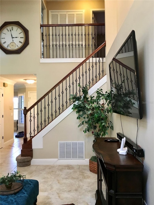 stairway with tile patterned floors