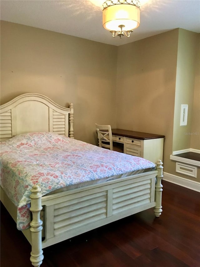 bedroom with dark wood-type flooring