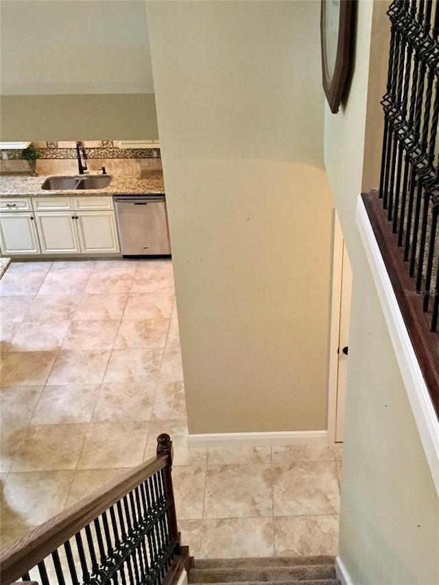 stairway with sink and tile patterned flooring