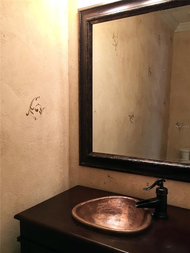 bathroom with crown molding, toilet, and vanity