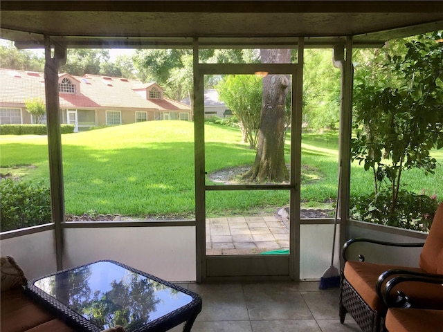 doorway to outside featuring a healthy amount of sunlight and tile patterned flooring