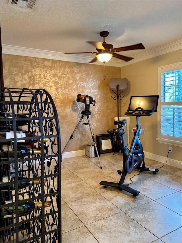 workout room featuring ornamental molding, ceiling fan, and a textured ceiling