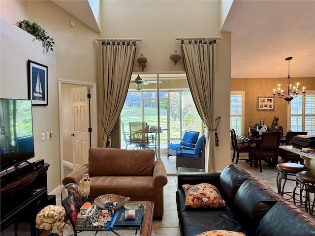 tiled living room featuring a notable chandelier and a high ceiling