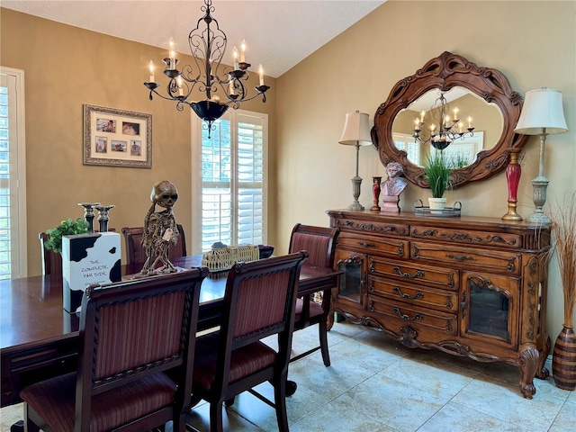 dining space with lofted ceiling and a notable chandelier