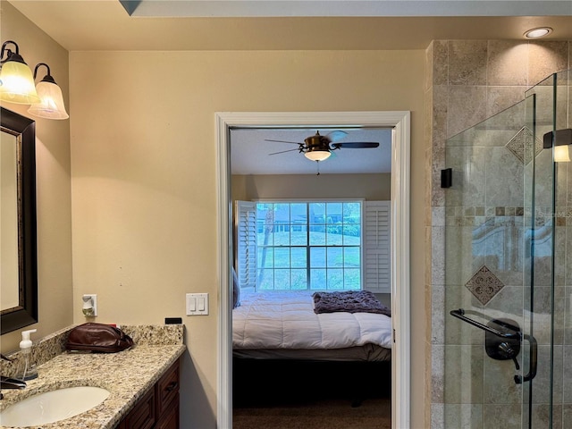 bathroom featuring vanity, ceiling fan, and a shower with shower door